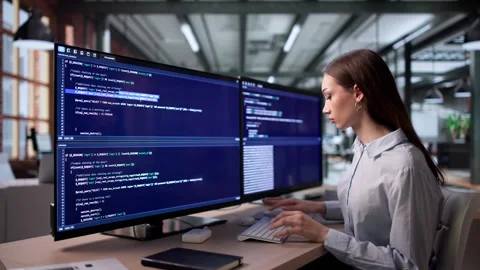 Young Woman Focused On Writing Software Code Stockbeeldmateriaal 335880357
