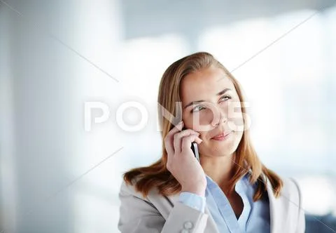Young woman in formalwear speaking by cellphone Stock Photos