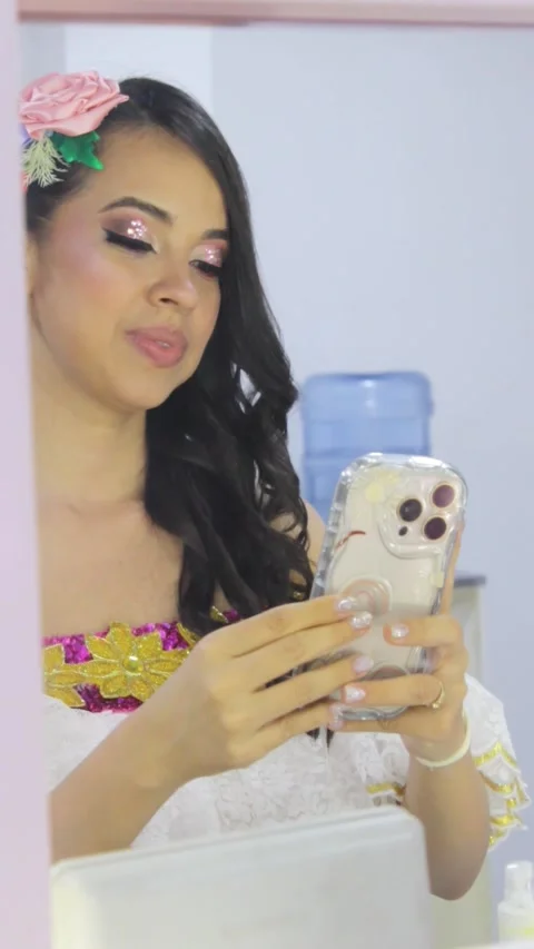 A young woman in front of a mirror checking her smartphone Stock Footage 311130634