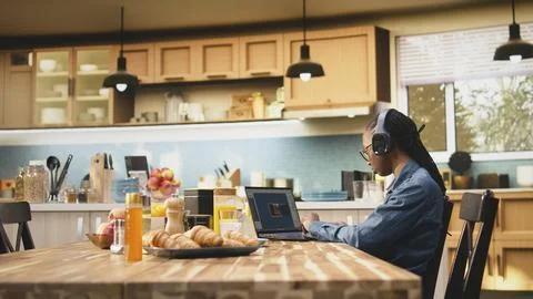 Young woman game developer with headset operates interactive gaming software Fotos Stock