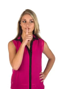 Young woman gesturing to keep quiteworking on a tablet Stock Photos