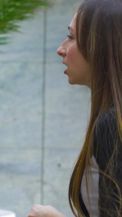 Young Woman Gesturing While Talking in Urban Outdoor Setting Stock-Footage 346813120