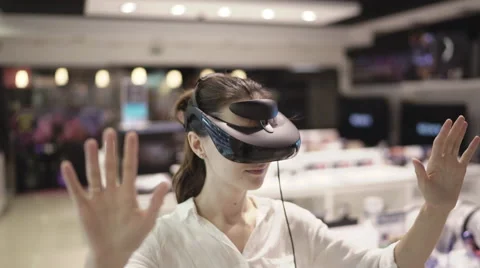 Young woman getting experience in using vr-headset in a mall Stock Footage 65174224