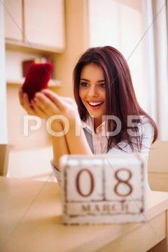 Young woman getting her present. march, 8. Stock Photos
