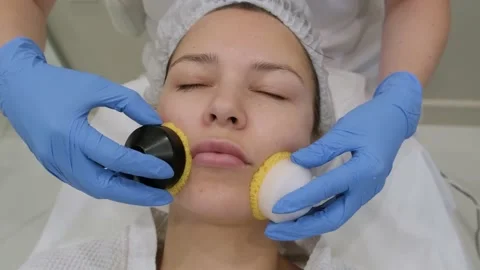 Young woman getting microcurrent therapy procedure for beautiful facial skin. Видео 209248464