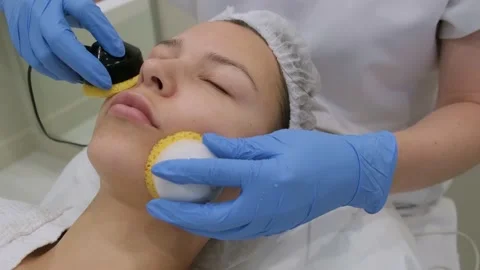 Young woman getting microcurrent therapy procedure for beautiful facial skin. Видео 211412616