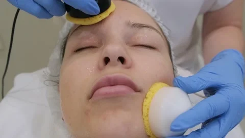 Young woman getting microcurrent therapy procedure for beautiful facial skin. Stockbeeldmateriaal 218088065