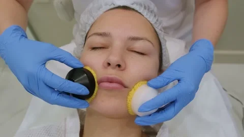 Young woman getting microcurrent therapy procedure for beautiful facial skin. Stock Footage 218593367