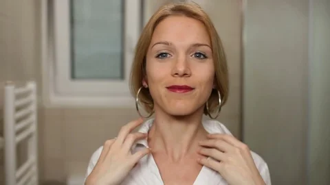 Young woman getting ready for work or a date. High definition video. Stock Footage 79484416