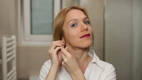 Young woman getting ready for work or a date. High definition video. Stock Footage 79484779
