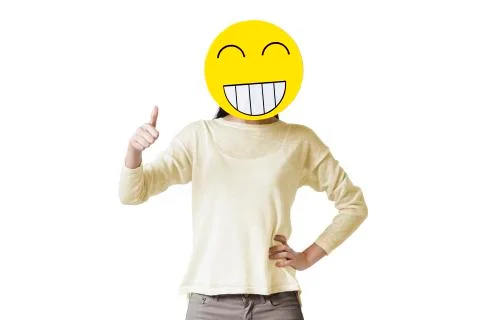 Young woman giving thumbs up with happy emoticon face in front of her face Stock Photos