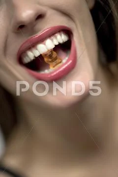 Young Woman With Gummi Bear In Mouth, Portrait