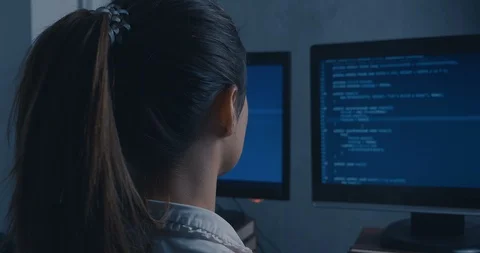 Young Woman Hacker Programmer working on computer at night, back side view Stock Footage 102422097