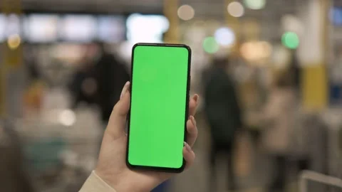 Young woman hand using smart phone with green screen in the market. close-up Stock Footage 170527515