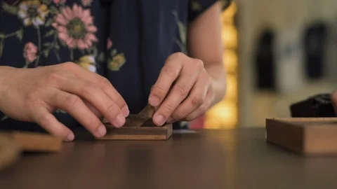 A young woman hands solving interlocking wooden puzzles. Video stock 104401476