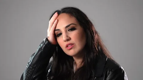 Young woman has problems or is suffering from headache Vídeo Stock 252302283