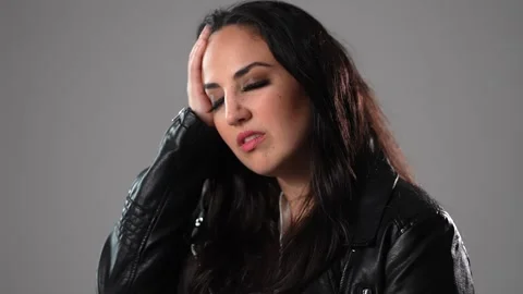Young woman has problems or is suffering from headache Vídeo Stock 252302883