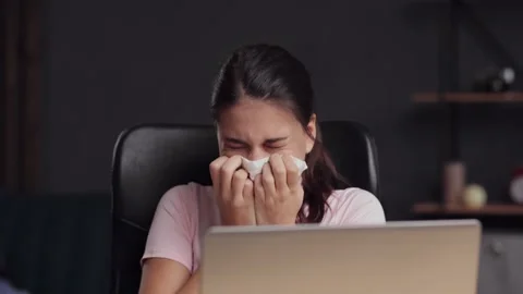 Young woman having allergy, flu and sneezing. girl blowing nose in paper tissue Stock Footage 166364077