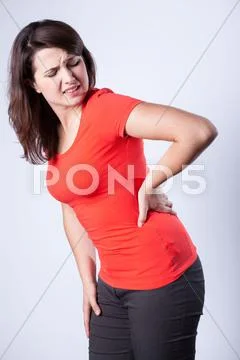 Young woman having back pain Stock Photos
