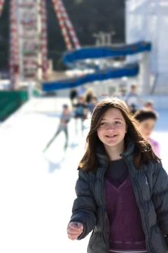 Young woman having fun while ice skating Stock Photos