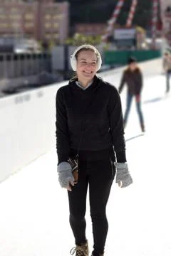 Young woman having fun while ice skating Stock Photos