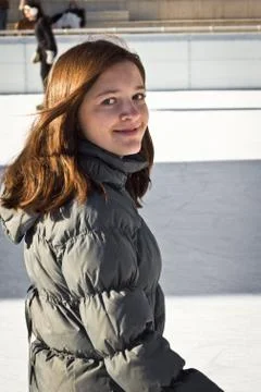 Young woman having fun while ice skating Stock Photos