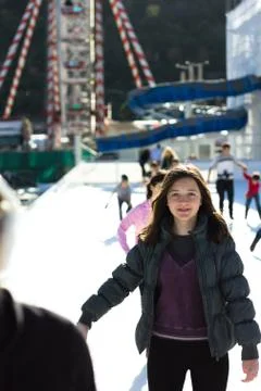 Young woman having fun while ice skating Stock Photos