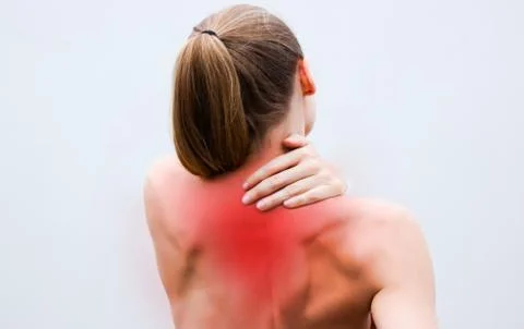 Young woman having pain in the back and neck. Health-care Concept. Stock Photos