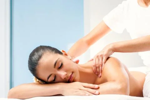 Young woman having spa back massage. Stock Photos