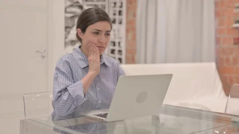 Young Woman having Toothache while Working on Laptop Stock Footage 238647501