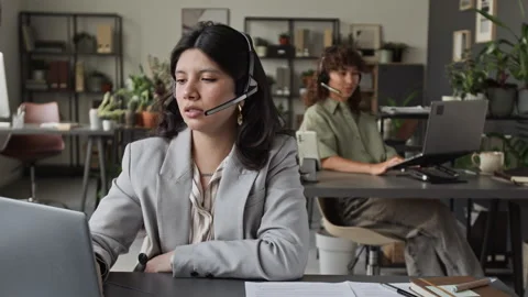 Young Woman with Headset Working in Customer Support Office Stock Footage 343617417