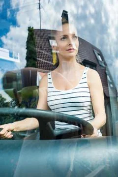 Young woman in her function as a bus driver 库存照片