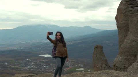 Young woman hiker taking photo with smart phone at mountain peak Video stock 59081466