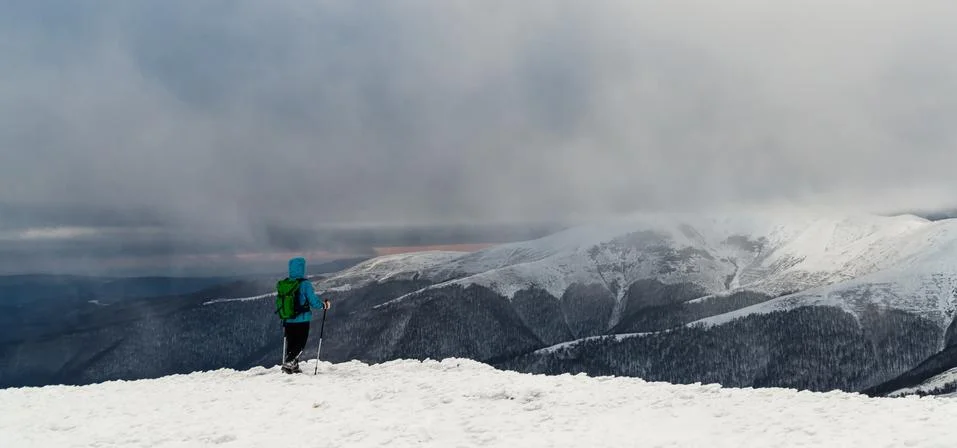Young woman hiking in the snow mountains Stock Photos