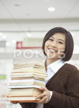 Young Woman Holding Books Stock Photos