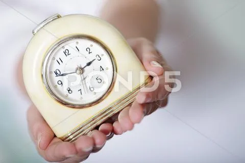 Young Woman Holding Clocks. Dof