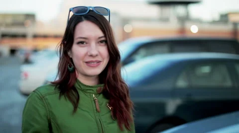 Young woman holding keys of new car and smiling Stock Footage