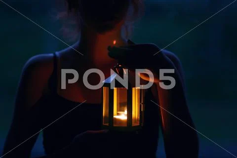 Young woman holding lantern Stock Photos