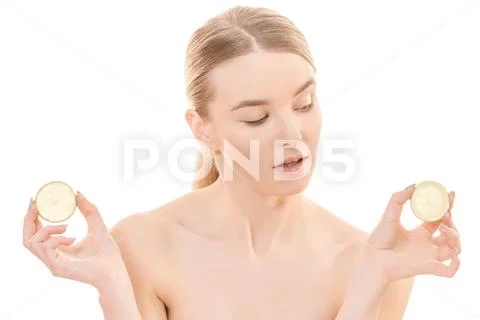 The young woman holding a lemon on the white background Stock Photos