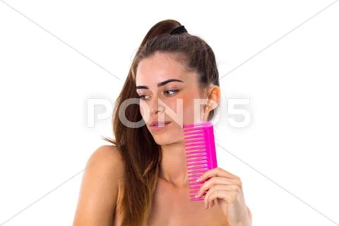 Young woman holding pink hair brush Stock Photos