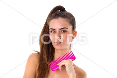 Young woman holding pink hair brush Stock Photos