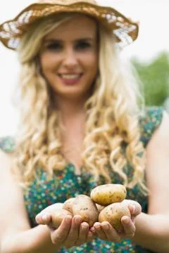 Young woman holding some potatoes Stock Photos