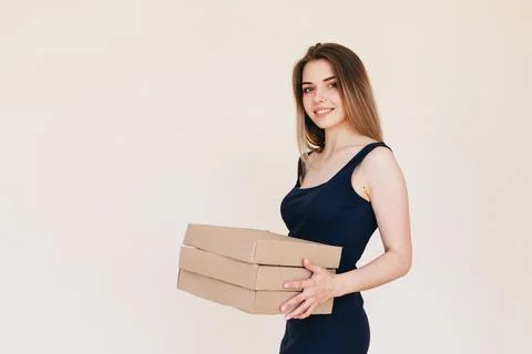 Young Woman Holding A Stack Of Boxes In Her Hands. Pizza Delivery Girl on a B Stock Photos