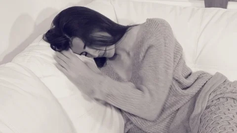 Young woman at home crying feeling depressed and lonely desaturated Stock Footage 75208917
