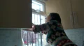 Young woman at home washing windows HD Footage