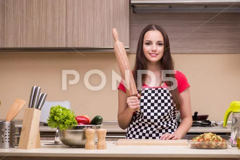 Young Woman Housewife Working In The Kitchen