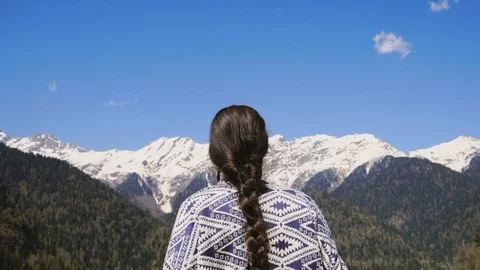 A young woman inhales clean and fresh mountain air in a nature reserve Stock Footage