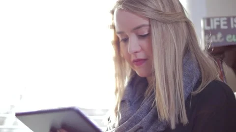 Young woman Inside Looking Down and Swiping Fingers Across iPad Tablet Stock Footage 62822686