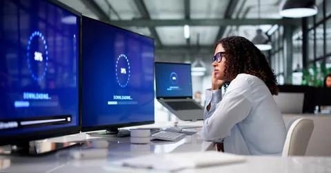 Young Woman Is Installing Important Software Update On Her Desktop Computer. Stock Photos
