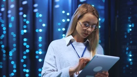 Young woman IT engineer working on digital tablet providing inspection in huge Stock Footage 118450501